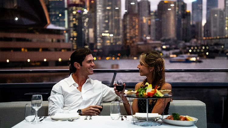 A couple enjoying a meal on the Clearview Glass Boat lunch cruise in Sydney